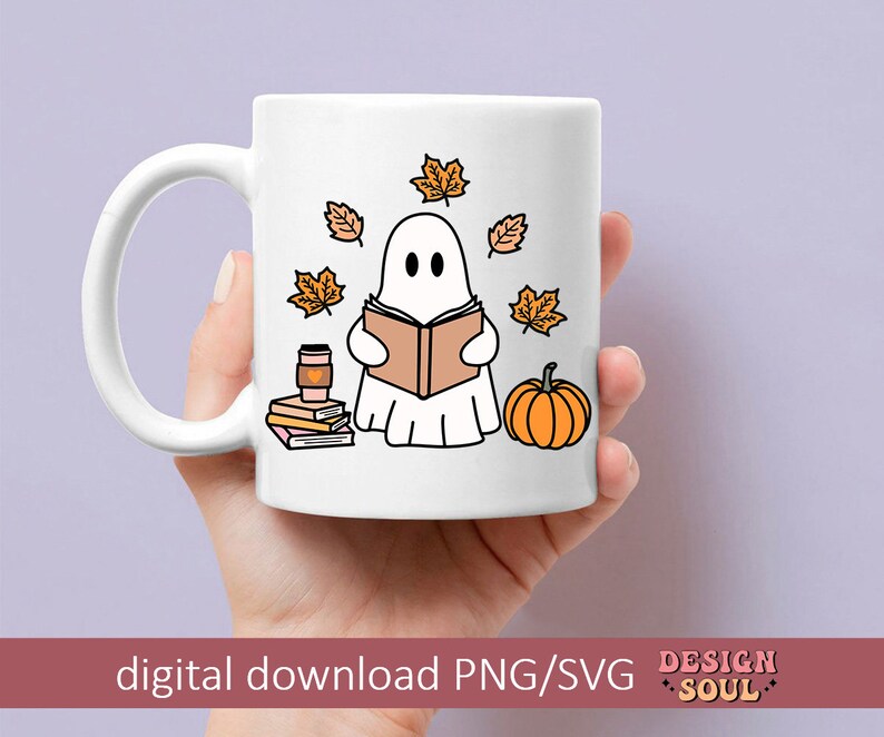 May include: White ceramic mug with a ghost reading a book, surrounded by fall leaves, a pumpkin, and a stack of books. The mug has a handle and the text "DESIGN SOUL" is printed on the bottom.