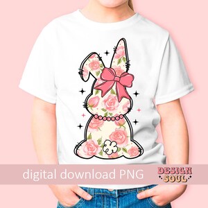 May include: A white t-shirt with a pink floral bunny graphic. The bunny has a pink bow and is outlined in black. The text "digital download PNG" and "Design Soul" are at the bottom of the image.