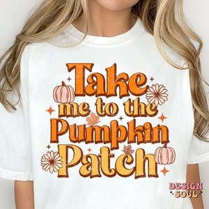 May include: White t-shirt with a vintage-style graphic that says "Take me to the Pumpkin Patch". The graphic features pumpkins, leaves, and flowers in orange, yellow, and brown.