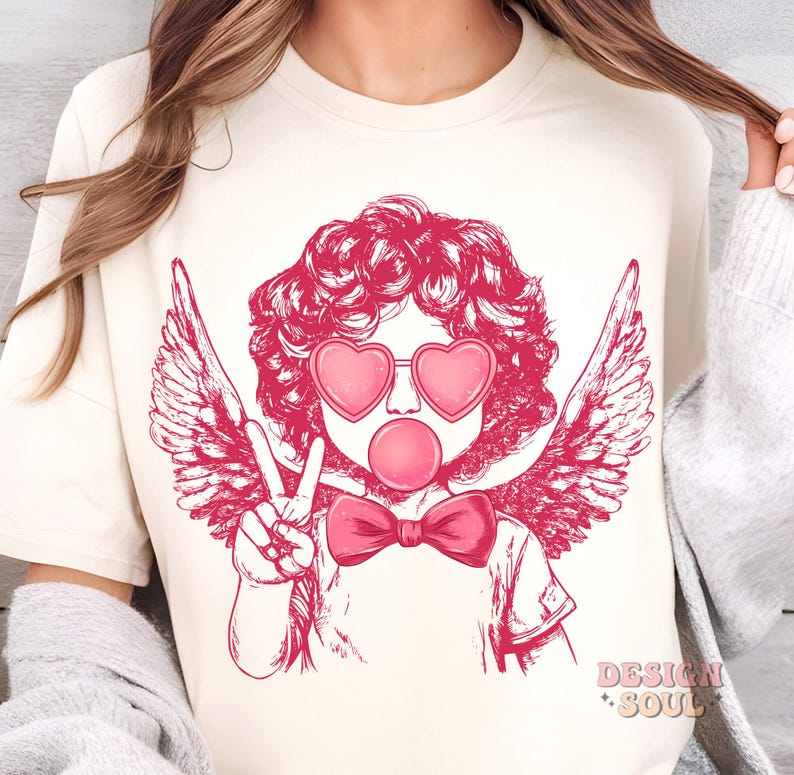 May include: A pink and white graphic design of a cherub with angel wings wearing heart-shaped sunglasses and blowing a bubble. The cherub is wearing a pink bow tie.