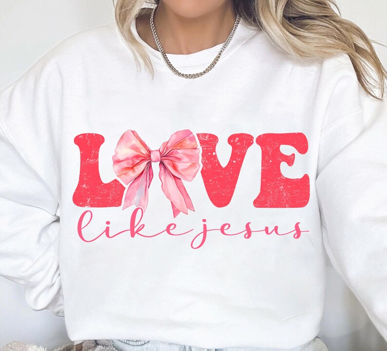 May include: White sweatshirt with a pink bow and the words "LOVE like jesus" in red.
