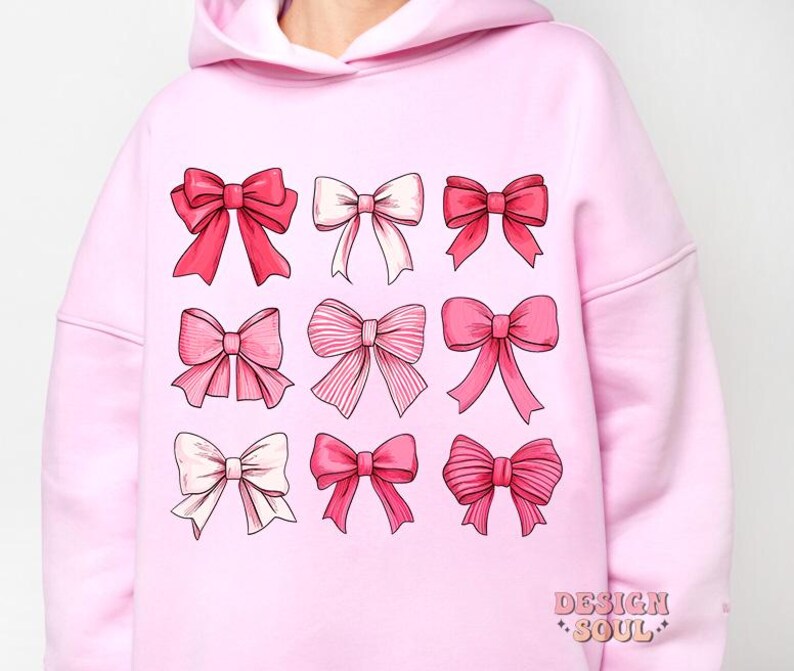 May include: Pink hoodie with a graphic print of nine pink bows in different styles. The text "DESIGN SOUL" is printed on the bottom right corner of the hoodie.