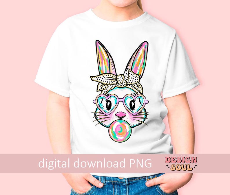 May include: A white t-shirt featuring a colourful graphic of a bunny wearing pink heart-shaped sunglasses and a polka dot headband. The bunny is holding a pink and blue lollipop in its mouth. The text "digital download PNG" is at the bottom of the shirt.