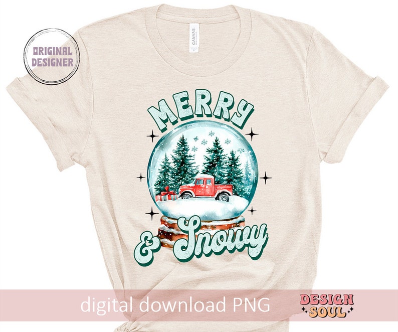 May include: A beige t-shirt featuring a snow globe design with a red truck, green trees, and white snow. The text "Merry & Snowy" is written in a retro font.
