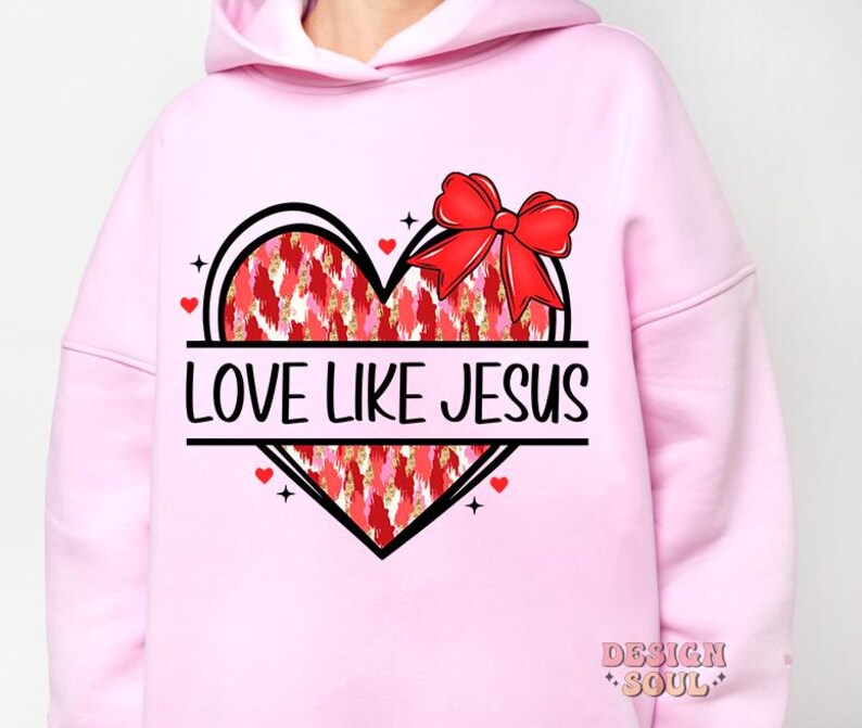 May include: Pink hoodie with a graphic of a red heart with a bow on top and the text "Love Like Jesus".