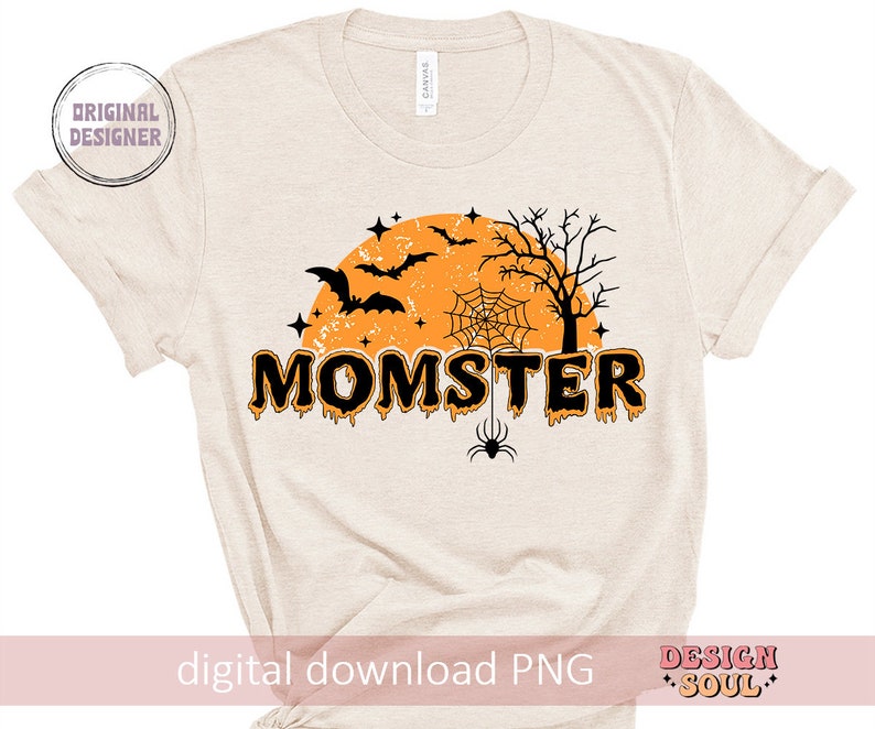 May include: A beige t-shirt with a black and orange graphic design. The design features a spooky Halloween theme with bats, a spider web, a spider, and a moon. The text "MOMSTER" is written in dripping orange letters.