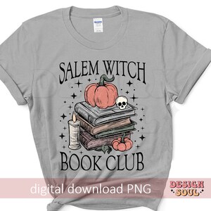 May include: A grey t-shirt with the text "Salem Witch Book Club" in black. The design features a stack of books, a pumpkin, a skull, and stars.