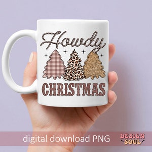 May include: White ceramic mug with a brown rope design and the text "Howdy Christmas". The mug features three Christmas trees with a plaid, leopard print, and glitter design.