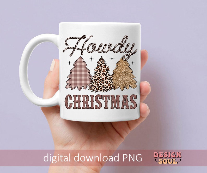 May include: White ceramic mug with a brown rope design and the text "Howdy Christmas". The mug features three Christmas trees with a plaid, leopard print, and glitter design.