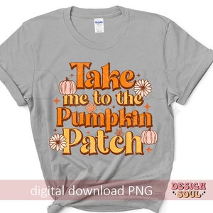 May include: A gray t-shirt with the text "Take me to the Pumpkin Patch" in orange and brown lettering. The text is surrounded by small orange pumpkins, brown leaves, and orange flowers.