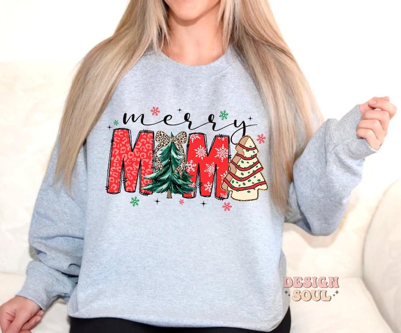 May include: A gray sweatshirt with the text "merry MAMA" in red and white letters with a green and white Christmas tree design.