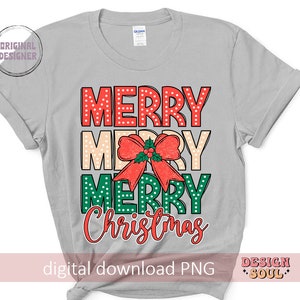 May include: A gray t-shirt with the text "Merry Merry Christmas" in red, green, and white polka dots. The text is layered with a red bow with green leaves.