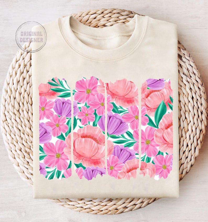 May include: A beige sweatshirt with a floral print design. The print features pink, purple, and green flowers.