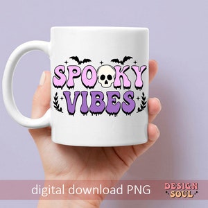May include: White ceramic mug with a pink and purple design that says "Spooky Vibes" with a skull and bats.