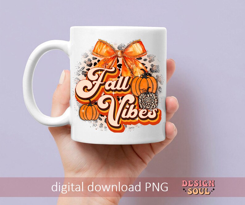 May include: White ceramic mug with a fall-themed design. The design features a large orange bow with glitter, pumpkins, and the text "Fall Vibes" in a retro font.