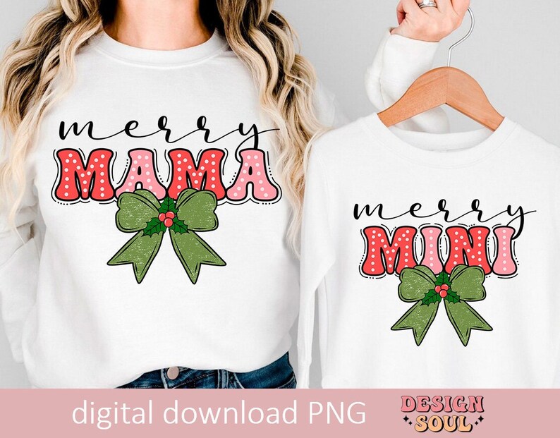 May include: Two white long-sleeve shirts with a Christmas theme. The larger shirt says "merry mama" in pink and red letters with white polka dots and a green bow with holly. The smaller shirt says "merry mini" in pink and red letters with white polka dots and a green bow with holly.