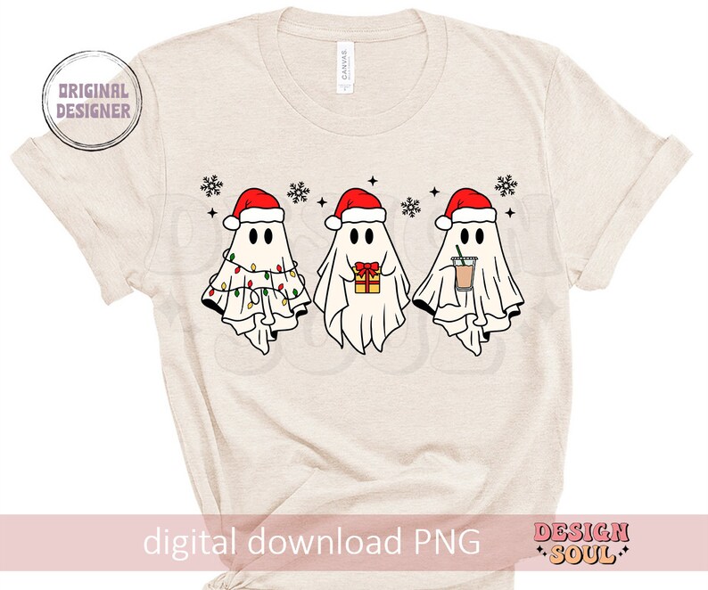 May include: A beige t-shirt with a digital download PNG graphic of three ghosts wearing Santa hats. The ghosts are holding gifts and a cup of coffee. The text "Design Soul" is in the bottom right corner.