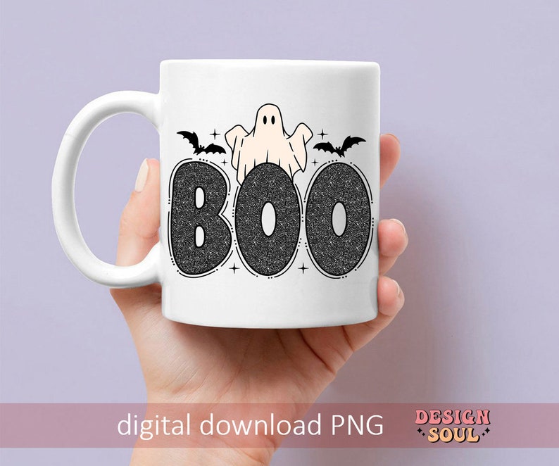 May include: White ceramic mug with a black and white design of a ghost and bats with the word "BOO" in black glitter letters.