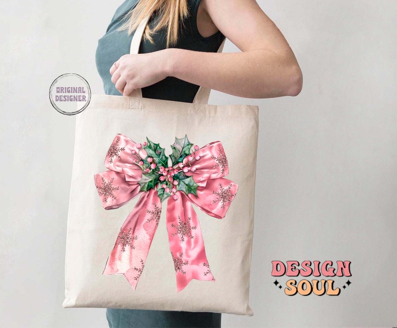 May include: A white tote bag with a pink bow and holly design. The bag has the text "DESIGN SOUL" printed on the bottom right corner.
