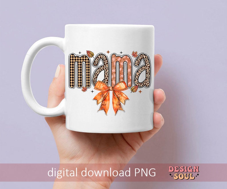 May include: White ceramic mug with a brown, black, and orange design that says "mama" with a bow.
