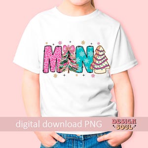May include: White t-shirt with a colorful design that says "Mama" with Christmas trees. The trees are decorated with pink, blue, and green patterns.