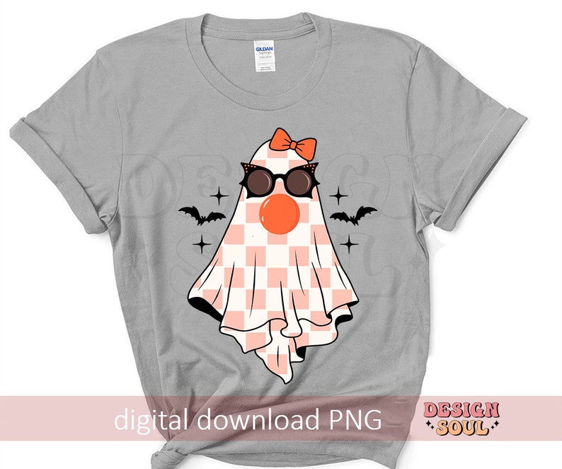 May include: A gray t-shirt with a pink and white checkered ghost wearing sunglasses and a pink bow. The ghost has a red nose and is surrounded by black bats and stars. The text "digital download PNG" and "DESIGN SOUL" are at the bottom of the shirt.