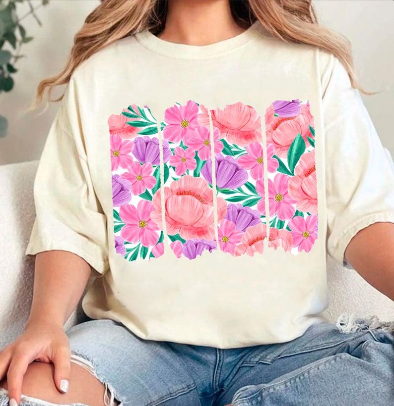 May include: A white t-shirt with a floral print featuring pink and purple flowers. The print is in a vertical stripe pattern.