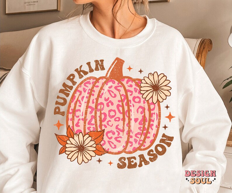 May include: White sweatshirt with a pink and brown leopard print pumpkin graphic and the text "Pumpkin Season".