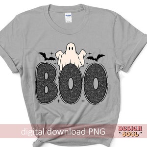 May include: A gray t-shirt with a black and white graphic of a ghost with bats and the word "BOO" in glitter letters.