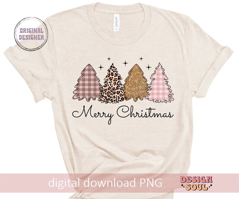 May include: A beige t-shirt with a design of three Christmas trees. The trees are pink and white gingham, leopard print, and gold glitter. The text "Merry Christmas" is below the trees.