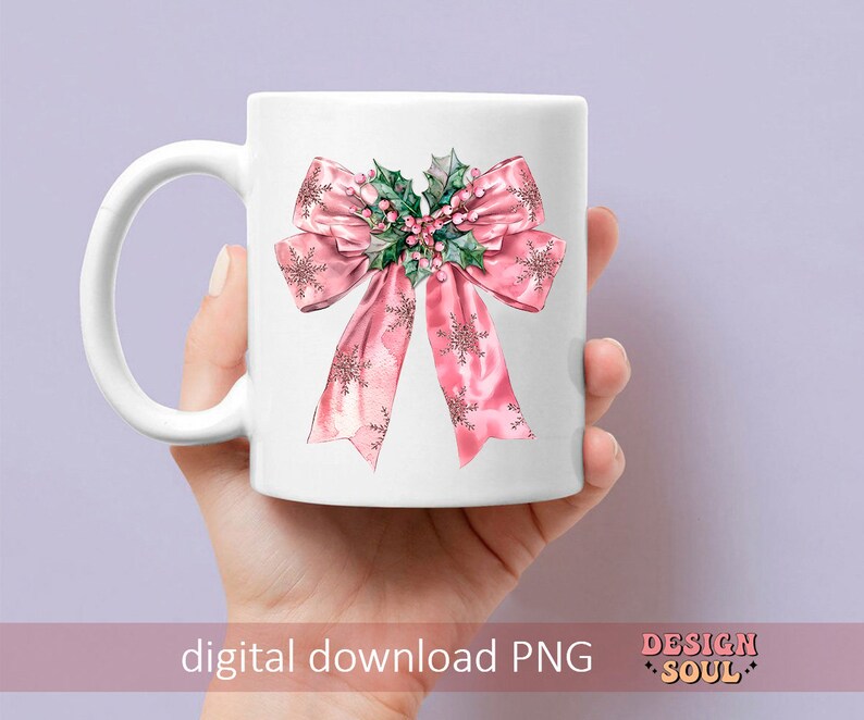May include: A white ceramic mug with a pink bow and green holly design. The bow has a snowflake pattern and the holly has red berries.