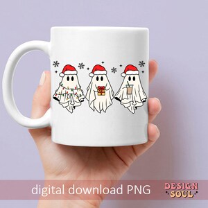 May include: White ceramic mug with a design of three ghosts wearing Santa hats. The ghosts are holding a gift, a cup of coffee, and a string of lights. The mug has a red handle and is on a white background.