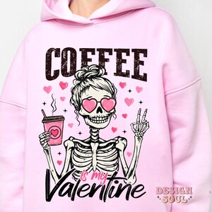 May include: Pink hoodie with a skeleton holding a coffee cup and the text "COFFEE is my VALENTINE".