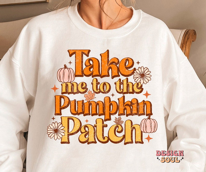 May include: White sweatshirt with a graphic print that says "Take me to the Pumpkin Patch" in orange, brown, and white text with fall-themed illustrations.