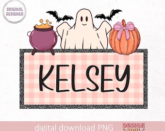 May include: A pink and white checkered sign with the name Kelsey written in black. The sign is decorated with a ghost, a pumpkin, and a cauldron.