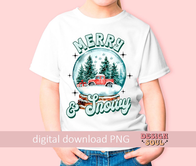 May include: A white t-shirt with a snow globe design featuring a red truck, green trees, and the text "Merry & Snowy".