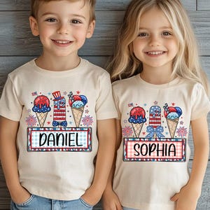 May include: Two children wearing cream-colored t-shirts with a patriotic ice cream design. The design includes ice cream cones, a popsicle, and the names "DANIEL" and "SOPHIA" in a red, white, and blue color scheme, perfect for a 4th of July celebration.