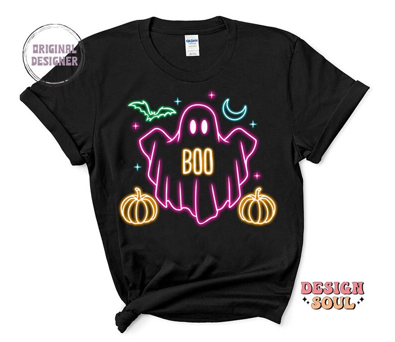 May include: Black t-shirt with a neon pink ghost with the word "BOO" inside. The ghost is surrounded by neon yellow stars, a crescent moon, and two pumpkins.