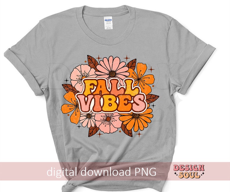 May include: A grey t-shirt featuring a floral design and the text "Fall Vibes" in orange, yellow and pink.