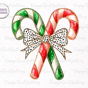 May include: Two candy canes with red and white stripes and green and white stripes are tied together with a black and white polka dot bow with gold glitter. The candy canes are also decorated with gold glitter.