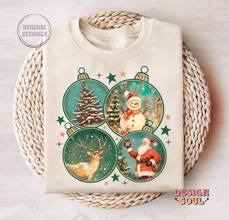 May include: A beige sweatshirt with a vintage Christmas design featuring four baubles. Each bauble depicts a different festive scene: a Christmas tree, a snowman, a reindeer, and Santa Claus.