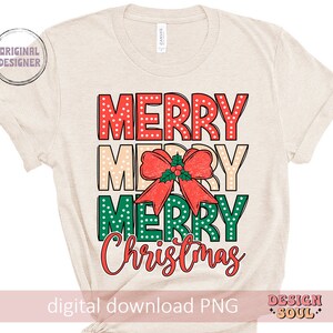 May include: A beige t-shirt with the text "Merry Merry Merry Christmas" in red, green, and white with a red bow and green holly leaves.