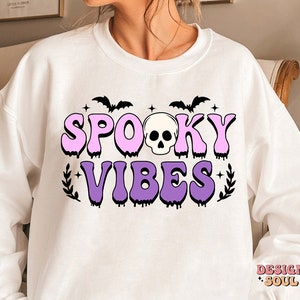 May include: White sweatshirt with a pink and purple graphic that says "Spooky Vibes" with a skull and bats.