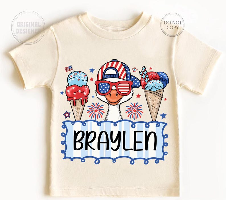 May include: Cream-colored t-shirt featuring a cartoon goose wearing a patriotic hat and sunglasses, with ice cream cones and fireworks. The name "BRAYLEN" is displayed in a blue and white frame. A fun, festive design for kids.