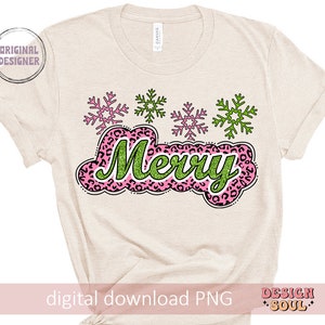 May include: A beige t-shirt with a pink and green "Merry" design. The design features a leopard print pattern and snowflakes.