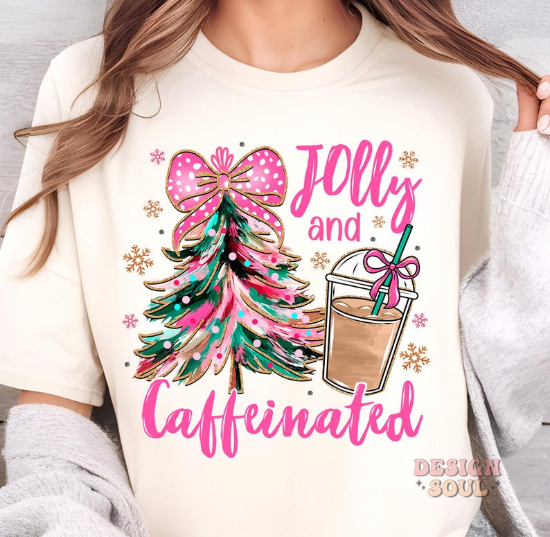 May include: A white t-shirt with a pink and gold Christmas tree, a pink bow, and a cup of coffee. The text "Jolly and Caffeinated" is written in pink letters.