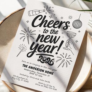 May include: A black and white New Year's invitation with the text "Cheers to the new year! 2026." The design includes illustrations of fireworks, a champagne bottle, a disco ball, and a champagne glass. The invitation is on a white paper.