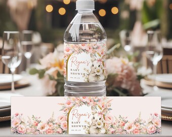 May include: A clear plastic water bottle with a white cap, wrapped with a label featuring a floral design and a bunny illustration. The label reads "Reyna's Baby Shower 04.19.23". The design includes pink and peach flowers.