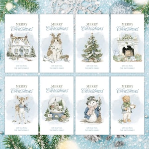 May include: A collection of eight Christmas cards with watercolor illustrations. Each card features a different festive image, including a house, cat, Christmas tree, fireplace, deer, snow globe, snowman, and teddy bear. The words "Merry Christmas" and a family name are printed on each card.