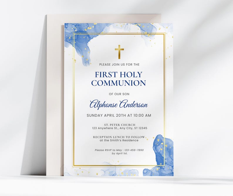 Modern blue First Communion invitation for boys featuring watercolor edges in blue and gold with a gold cross, elegant serif fonts, and white background placed on a folded envelope.